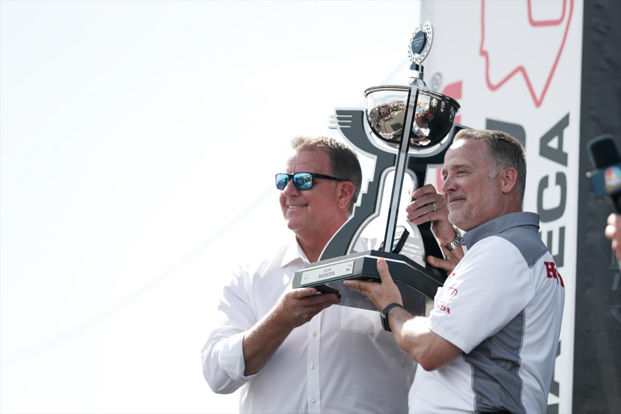 Jay Frye, INDYCAR president, presents the manufacturer championship trophy to Ted Klaus, president of Honda Performance Development  -- Photo by: Joe Skibinski