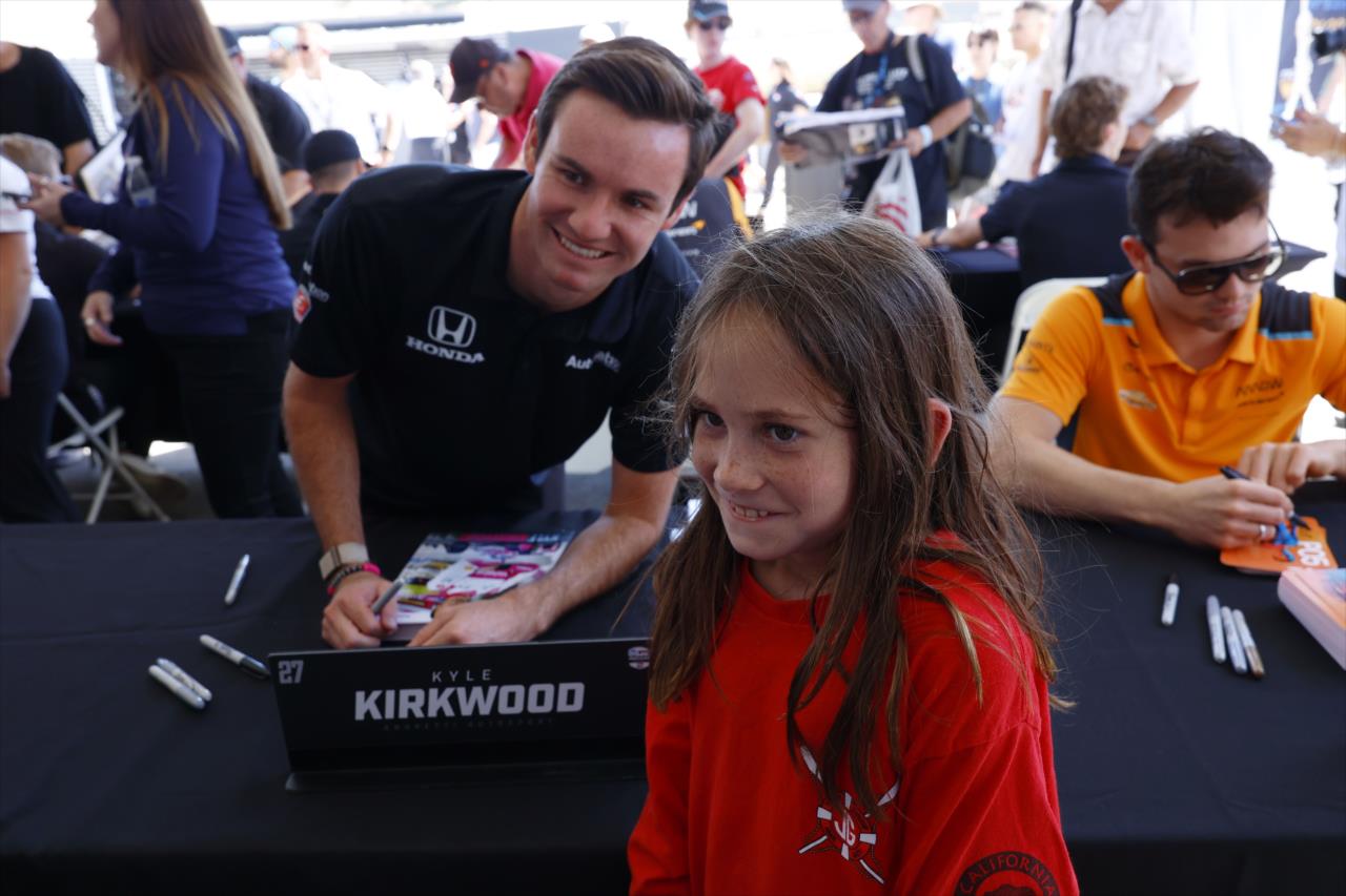 Kyle Kirkwood and Fan - Firestone Grand Prix of Monterey - By: Chris Jones -- Photo by: Chris Jones