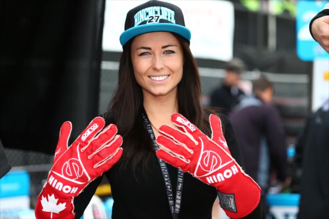 Kirsten Dee poses with James Hinchcliffe's red gloves at Long Beach -- Photo by: Chris Jones