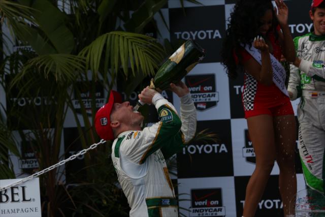 Mike Conway enjoys the champagne following his victory -- Photo by: Chris Jones