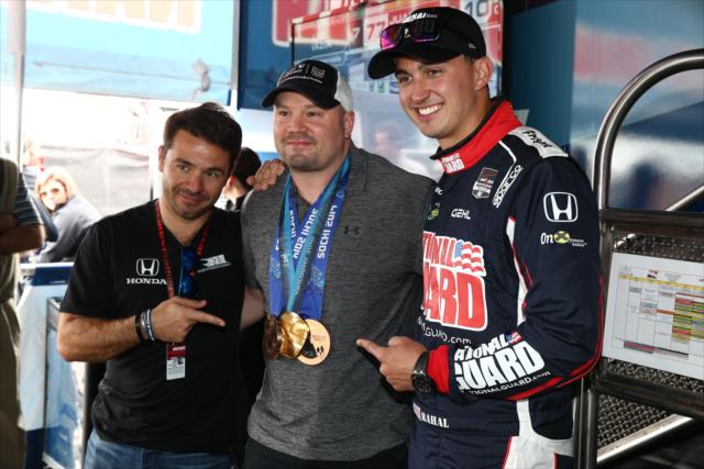 Oriol Servia and Graham Rahal pose with Olympian Bobsledder Steve Holcomb in the Rahal Letterman Lanigan paddock -- Photo by: Chris Jones