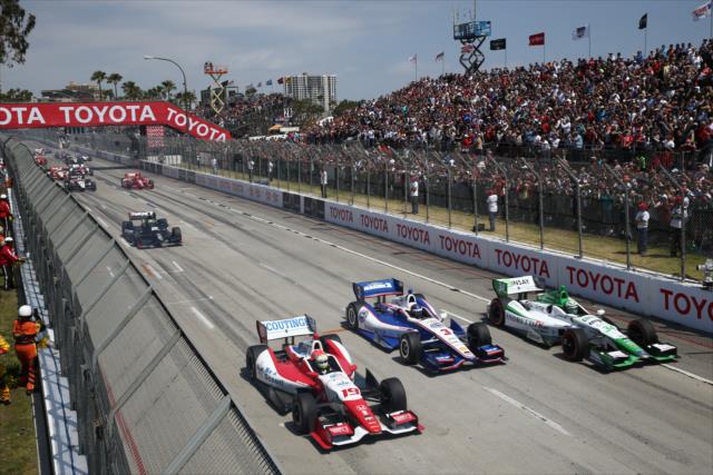 The field streaks down the main straight after the standing start -- Photo by: Chris Jones