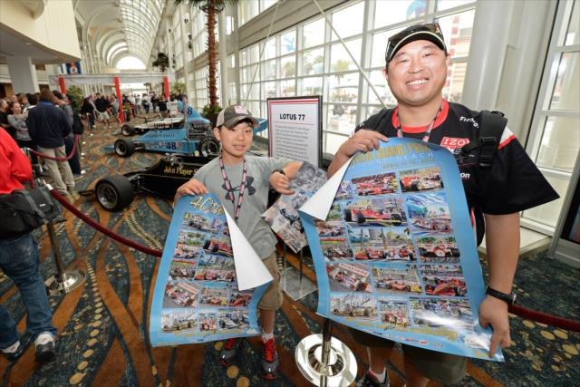 Fans pose with their 40th Anniversary Toyota Grand Prix of Long Beach posters -- Photo by: John Cote