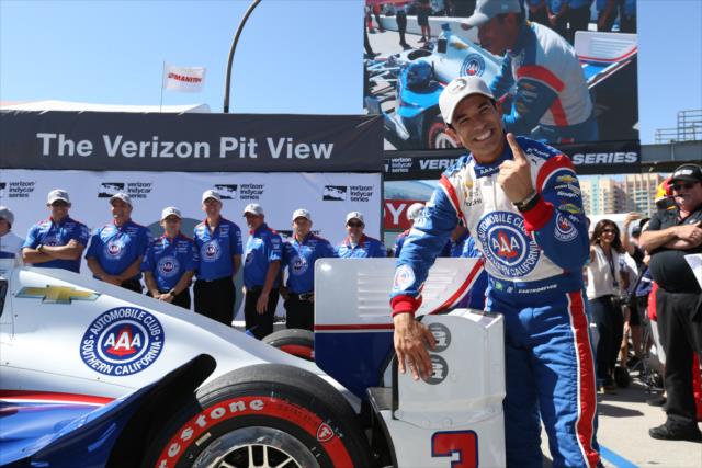 Helio Castroneves affixes the Verizon P1 Award emblem for winning the pole for the Toyota Grand Prix of Long Beach -- Photo by: Chris Jones
