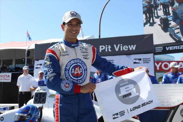 Helio Castroneves with the Verizon P1 Award flag for winning the pole for the Toyota Grand Prix of Long Beach -- Photo by: Chris Jones