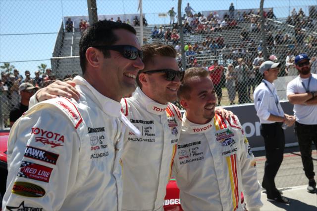 Max Papis and actors Brett Davern and Frankie Muniz during pre-race festivities for the Toyota Celebrity Pro-Am Race on the Streets of Long Beach -- Photo by: Chris Jones