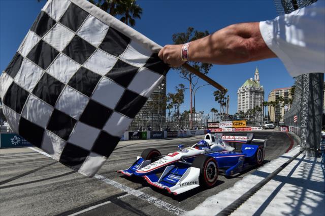 Helio Castroneves takes the checkered flag during qualifications for the Toyota Grand Prix of Long Beach -- Photo by: Chris Owens