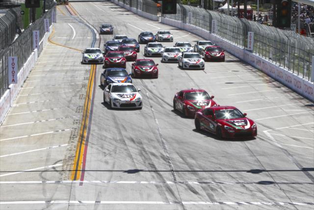 The field streams into Turn 1 during the Toyota Celebrity Pro-Am race on the Streets of Long Beach -- Photo by: Richard Dowdy