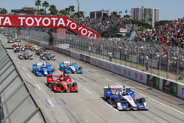 Helio Castroneves and Scott Dixon lead the field down the frontstretch during the parade laps prior to the start of the Toyota Grand Prix of Long Beach -- Photo by: Chris Jones