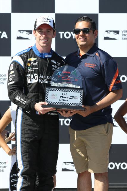 Simon Pagenaud accepts his 1st Place trophy in Victory Circle following his win in the Toyota Grand Prix of Long Beach -- Photo by: Chris Jones