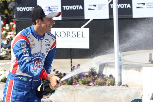 Helio Castroneves sprays the champagne in Victory Circle following the Toyota Grand Prix of Long Beach -- Photo by: Chris Jones