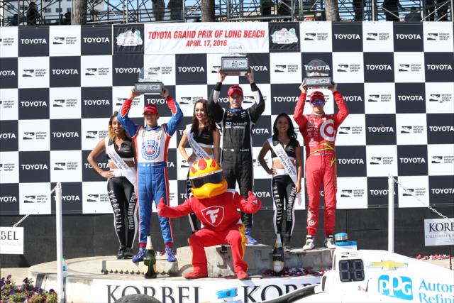 Simon Pagenaud, Scott Dixon, and Helio Castroneves hoist their trophies in Victory Circle following the Toyota Grand Prix of Long Beach -- Photo by: Chris Jones