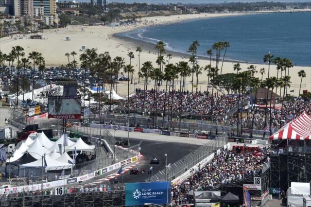 The field streams through Turn 10 during the Toyota Grand Prix of Long Beach -- Photo by: Chris Owens