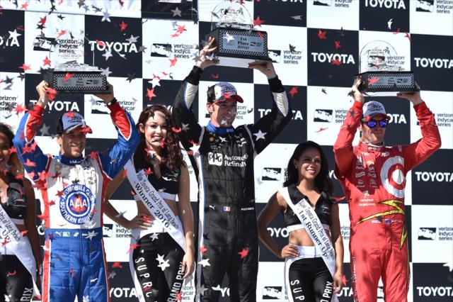 Simon Pagenaud, Scott Dixon, and Helio Castroneves hoist their trophies in Victory Circle following the Toyota Grand Prix of Long Beach -- Photo by: Chris Owens