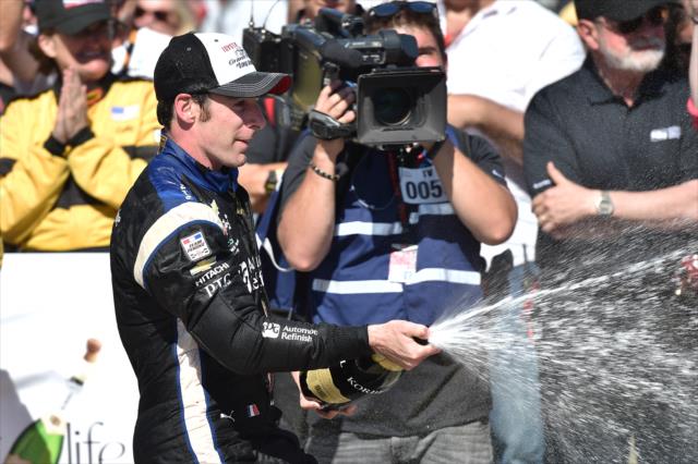 Simon Pagenaud sprays the champagne in Victory Circle following his win in the Toyota Grand Prix of Long Beach -- Photo by: Chris Owens