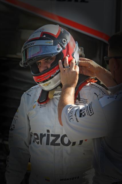 Juan Pablo Montoya gets a helmet adjustment prior to the final warmup for the Toyota Grand Prix of Long Beach -- Photo by: Richard Dowdy