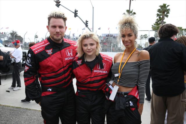 Dennis Jauch, Chloe Grace Moretz, and Leona Lewis on pit lane prior to their two-seater rides around the streets of Long Beach -- Photo by: Chris Jones