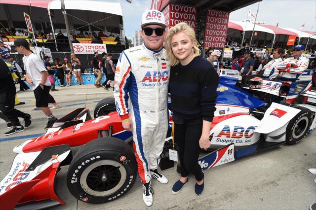 Conor Daly and Chloe Grace Moritz pose for a photograph during pre-race festivities for the Toyota Grand Prix of Long Beach -- Photo by: Christopher Owens