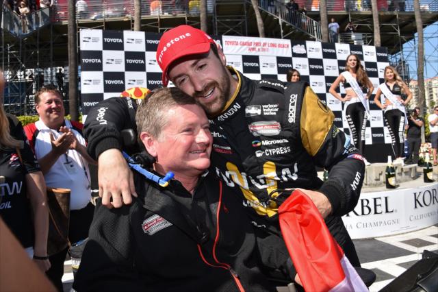 James Hinchcliffe gives team owner Sam Schmidt a hug after winning the Toyota Grand Prix of Long Beach -- Photo by: Christopher Owens