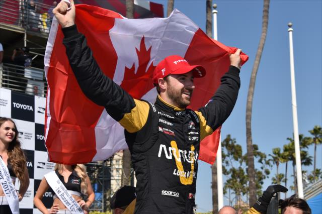 James Hinchcliffe hoists the Canadian flag in Victory Circle after winning the Toyota Grand Prix of Long Beach -- Photo by: Christopher Owens