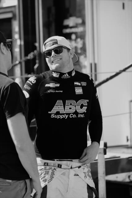 Conor Daly chats with a friend in the Long Beach paddock -- Photo by: Richard Dowdy