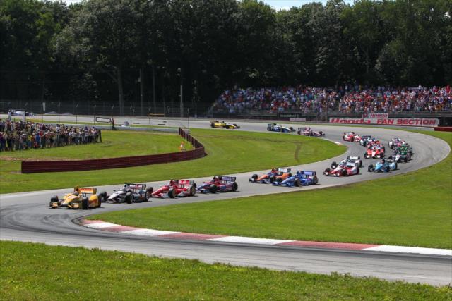The field streaks through the Esses at the start of the Honda Indy 200 at Mid-Ohio -- Photo by: Chris Jones