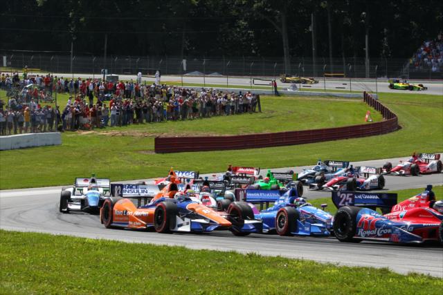 The field makes it cleanly through the Esses at the start of the Honda Indy 200 at Mid-Ohio -- Photo by: Chris Jones