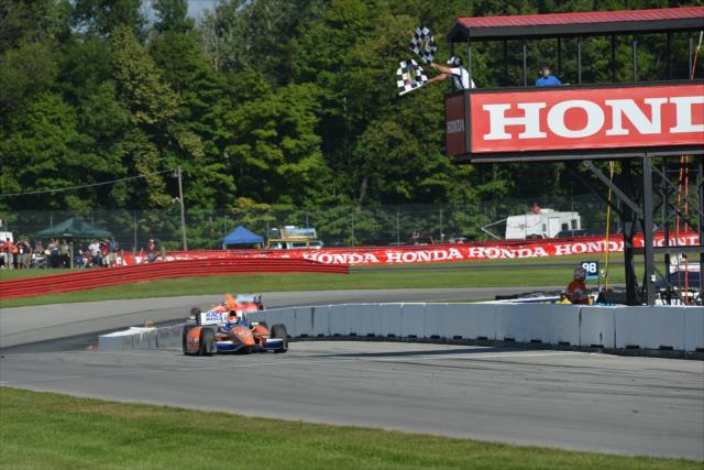Charlie Kimball takes the twin checkers and wins the Honda Indy 200 at Mid-Ohio -- Photo by: John Cote