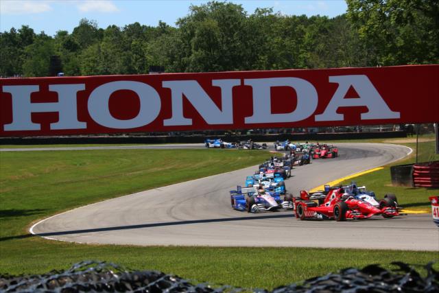 The field passes underneath the Honda bridge in Turn 7 during the Honda Indy 200 at Mid-Ohio -- Photo by: Bret Kelley