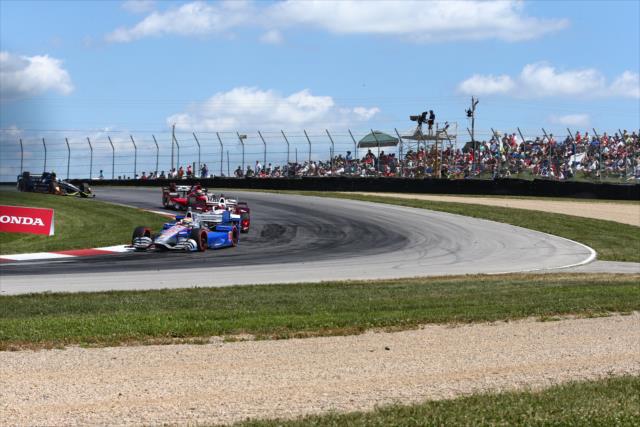 Justin Wilson leads a group through the Turn 2 Keyhole turn during the Honda Indy 200 at Mid-Ohio -- Photo by: Bret Kelley