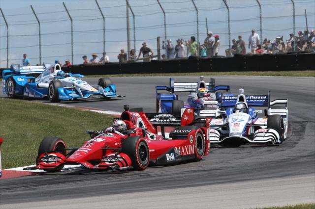 Graham Rahal leads a group through the Turn 2 Keyhole turn during the Honda Indy 200 at Mid-Ohio -- Photo by: Chris Jones