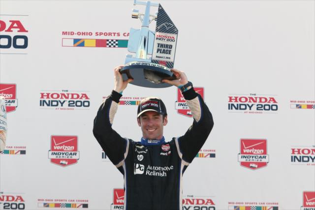 Simon Pagenaud hoists his third place trophy in Victory Circle following the Honda Indy 200 at Mid-Ohio -- Photo by: Chris Jones