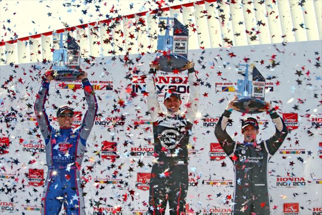 The confetti flies over Graham Rahal, Justin Wilson, and Simon Pagenaud in Victory Circle following the Honda Indy 200 at Mid-Ohio -- Photo by: Chris Jones