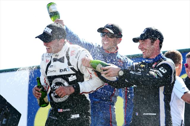 Justin Wilson and Simon Pagenaud give winner Graham Rahal a champagne shower in Victory Circle following the Honda Indy 200 at Mid-Ohio -- Photo by: Chris Jones