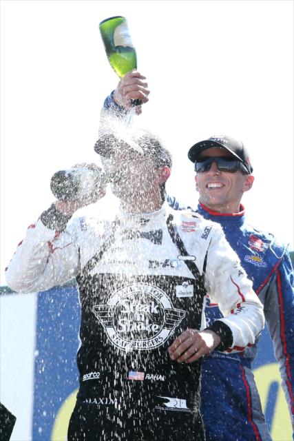 Justin Wilson pours the champagne over Graham Rahal in Victory Circle following the Honda Indy 200 at Mid-Ohio -- Photo by: Chris Jones