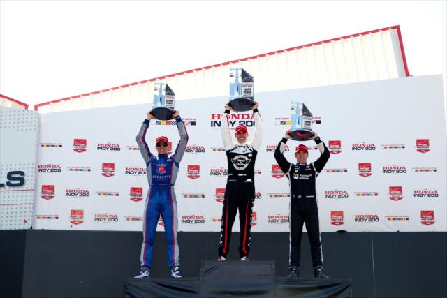 The podium of Graham Rahal, Justin Wilson, and Simon Pagenaud hoist their trophies in Victory Circle following the Honda Indy 200 at Mid-Ohio -- Photo by: Chris Jones
