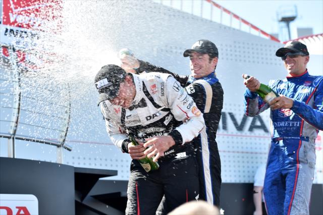 Simon Pagenaud and Justin Wilson let the chanmpagne fly on Graham Rahal in Victory Circle following the Honda Indy 200 at Mid-Ohio -- Photo by: Chris Owens