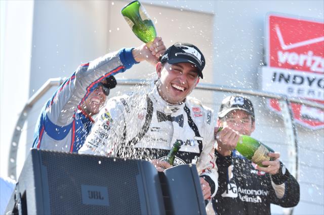 Graham Rahal gets a champagne shower from podium members Justin Wilson and Simon Pagenaud following the Honda Indy 200 at Mid-Ohio -- Photo by: Chris Owens