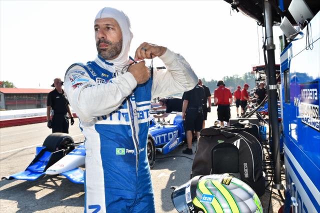 Tony Kanaan adjusts his firesuit along pit lane prior to the team test at Mid-Ohio Sports Car Course -- Photo by: Chris Owens