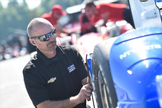 A Chip Ganassi Racing Teams engineer look over the No. 10 NTT Data Chevrolet of Tony Kanaan on pit lane -- Photo by: Chris Owens
