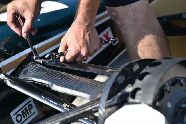 An Ed Carpenter Racing engineer makes a suspension adjustment on pit lane -- Photo by: Chris Owens