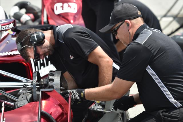 Team Penske engineers look over the suspension of Juan Pablo Montoya's No. 2 Hawk Chevrolet on pit lane -- Photo by: Chris Owens
