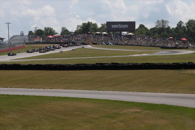 The field streams up through the Turn 2 Keyhole turn prior to the start of the Honda Indy 200 at Mid-Ohio -- Photo by: Bret Kelley