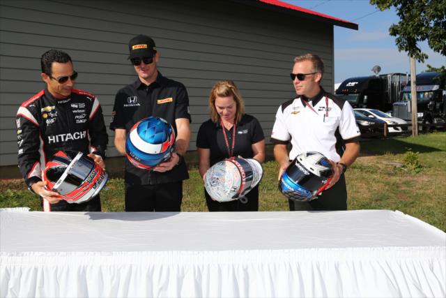 Helio Castroneves, Ryan Hunter-Reay, Sarah Fisher, and Ed Carpenter receive their recovered helmets that were previously stolen from INDYCAR. -- Photo by: Chris Jones
