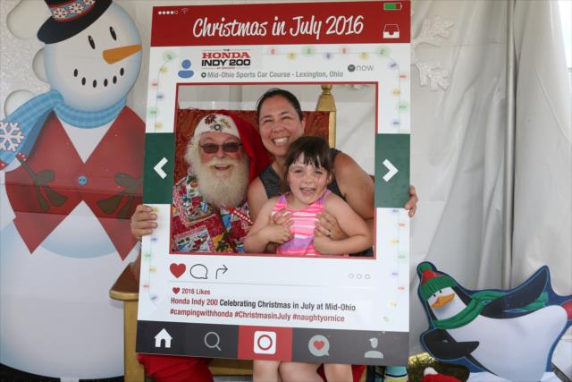 Santa Claus gets in on the selfie action during Christmas in July celebration in the INDYCAR Fan Village at the Mid-Ohio Sports Car Course -- Photo by: Chris Jones