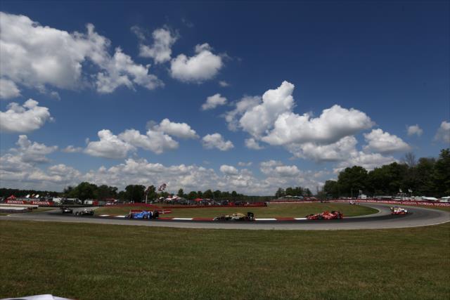 The field streams through the Turn 12 Carousel turn during the parade laps prior to the start of the Honda Indy 200 at Mid-Ohio -- Photo by: Chris Jones