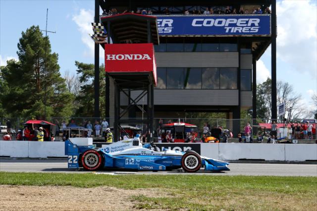 Simon Pagenaud takes the twin checkers to win during the Honda Indy 200 at Mid-Ohio -- Photo by: Chris Jones