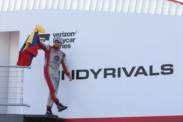 Carlos Munoz waives the Colombian flag in Victory Lane after his 3rd Place finish in the Honda Indy 200 at Mid-Ohio -- Photo by: Chris Jones