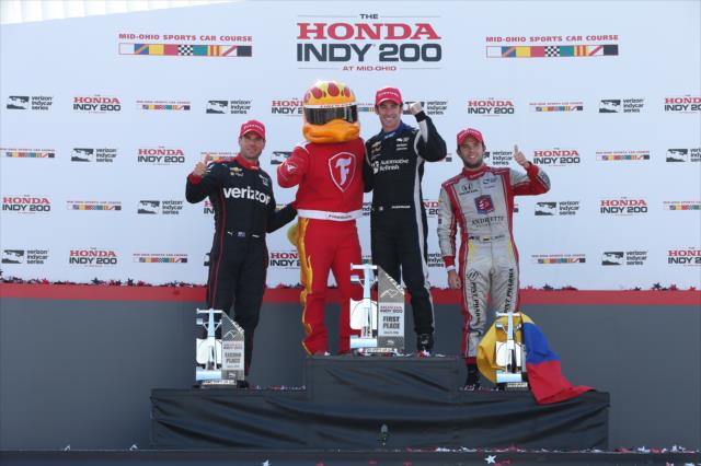 The podium of Simon Pagenaud, Will Power, and Carlos Munoz with the Firestone Firehawk in Victory Circle following the Honda Indy 200 at Mid-Ohio -- Photo by: Chris Jones