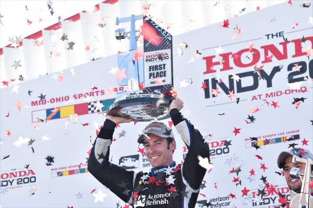 Simon Pagenaud hoists his trophy in Victory Lane following his win in the Honda Indy 200 at Mid-Ohio -- Photo by: Chris Owens